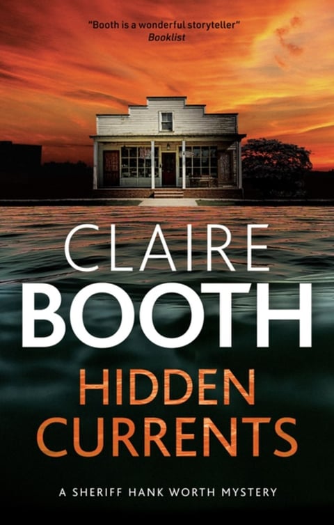 an historic western looking building under a red sky with author name Claire Booth and title Hidden Currents