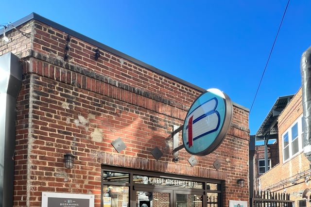 A historic brick building with a large marquee sign featuring the Bookmarks logo